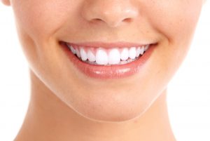 Healthy woman teeth and smile. Isolated over white background.